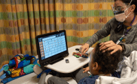 therapist and child using AAC