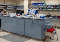 wide view of pharmacy with two technicians filling orders