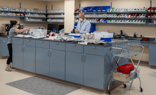 wide view of pharmacy with two technicians filling orders