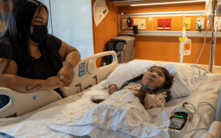 Mom with young daughter in a hospital bed