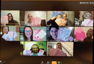 A zoom meeting depicting young professionals displaying valentines