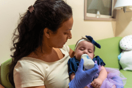 Therapist feeding baby with bottle