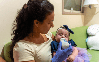 Therapist feeding baby with bottle