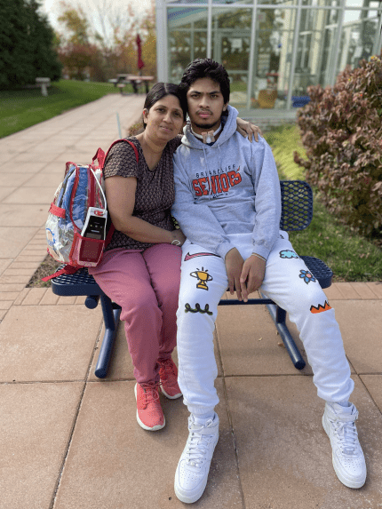 two people sitting on bench