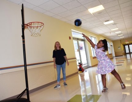 little girl shooting basketball