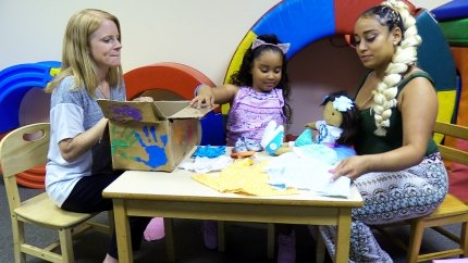 three women with doll 