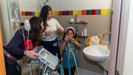 girl in bathroom showing therapists different makeup products