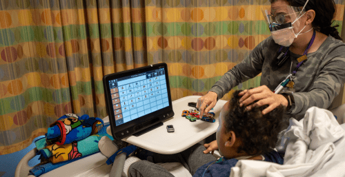 therapist and child using AAC